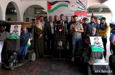 Disabled Palestinians hold banners during a portest against the killing of a disabled Iyad Hallaq, who was shot dead by Israeli police after they mistakenly thought he was armed with a pistol in Gaza city on June 3, 2020...