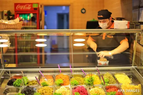 Turks, some wearing masks as a precaution against the spread of the coronavirus disease (COVID-19), sit in cafes, after the decision to open restaurants, cafes, cafeterias and public places in Istanbul, Turkey on June 3,...