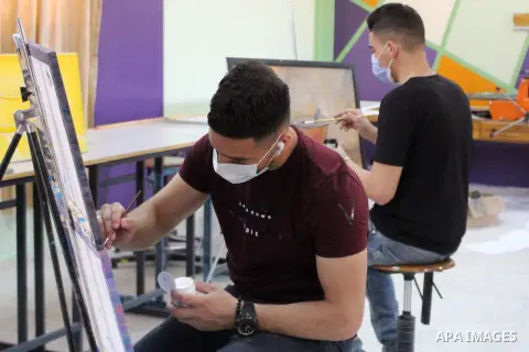Palestinian students wearing masks as a precaution against the spread of the coronavirus disease (COVID-19), attend their final classes before graduation following the reopening of the Palestine Technical University in a...