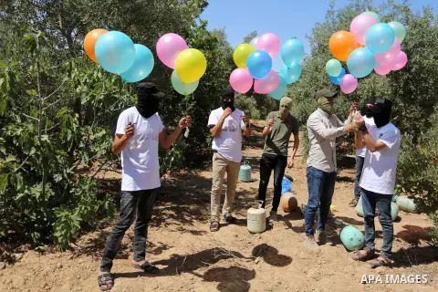 Palestinians prepare balloons attached with flammable materials at the Israel-Gaza border, in al-Bureij refugee camp in the center of Gaza Strip on June 12, 2020. Photo by Ashraf Amra