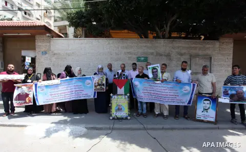 Palestinians take part in a protest in solidarity with prisoners in Israeli jails, in front of the Red cross office, in Gaza city on June 18, 2020. Photo by Mahmoud Ajjour