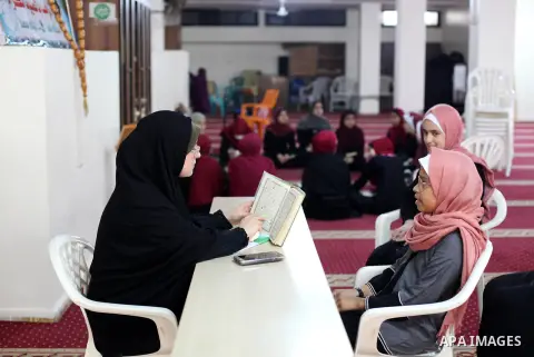 Palestinian girls attend a Quran lesson, during summer vacation at a Mosque, in Gaza city, on June 18, 2020. Photo by Mahmoud Ajjour