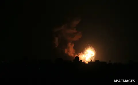 Flame and smoke are seen during an Israeli air strike, in Khan Younis in the southern Gaza Strip, on June 26, 2020. Photo by Ashraf Amra