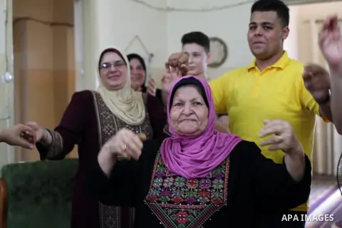 A Palestinian high school female student, Dalal saqallah 87.7%, and her son Diaa high school male student 60.7%, celebrates with her family after heard the results of her final exams known as ''Tawjihi'', in Gaza city on...