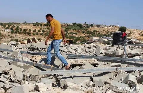 A Palestinian inspects the rubble of houses which were demolished by the Israeli army in Bani Naim town, east of the southern West Bank city of Hebron, July 21, 2020. Photo by Mosab Shawer