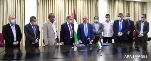 Palestinian Prime Minister Mohammad Ishtayeh, attends signing a memorandum of understanding between "Refugee Affairs" and "Waqfet Ezz" to support the needy students in the camps, in the West Bank city of Ramallah, on Jul...