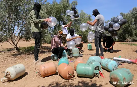 Palestinians prepare balloons attached with flammable materials at the Israel-Gaza border, in al-Bureij refugee camp in the center of Gaza Strip on August 10, 2020. Photo by Ashraf Amra