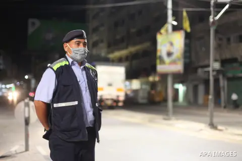 Palestinian policemen wearing a protective face masks stand guard after Gaza reported its first cases of COVID-19 in the general population, in Gaza city, on August 24, 2020. Photo by Mahmoud Ajjour