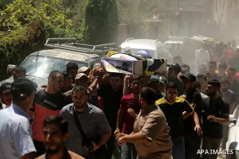 Palestinian mourners carry the coffins of members of the Islamic Jihad militant group during their funeral procession in Gaza City, on August 25, 2020. Four members of Palestinian militant group Islamic Jihad were killed...