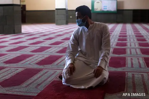 Palestinian imam of the mosque prays at a mosque is empty of worshipers, during the imposed lockdown to mitigate virus outbreak in the Gaza Strip, in Gaza city on August 28, 2020, during a lockdown in the Palestinian enc...