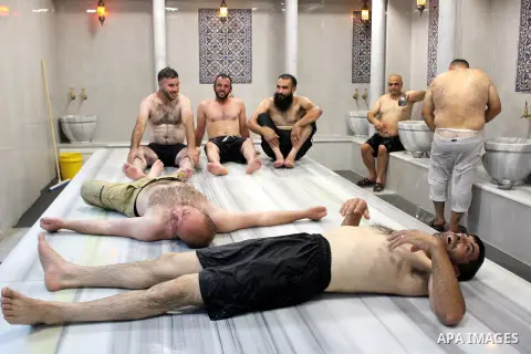 Palestinians bathe together in a pool at a Hammam (Turkish-style bathhouse) in the West Bank city of Hebron, on August 28, 2020, at which groups of ten are admitted at a time to reduce congestion as part of COVID-19 coro...