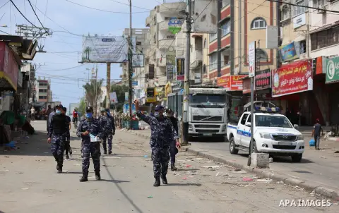 Palestinian policemen wear face masks, guard a barrier blocking a road, in Deir Al-Balah, in the center of the Gaza Strip, on Sept. 10, 2020, during a lockdown amid the COVID-19 pandemic. Photo by Ashraf Amra