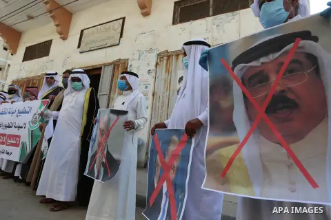 Palestinian men carry the exed out portraits of the Bahraini King, US President and Israeli Premier during a protest to condemn the normalisation of ties between Israeli and Bahrain in Deir al-Balah, in central Gaza Stri...