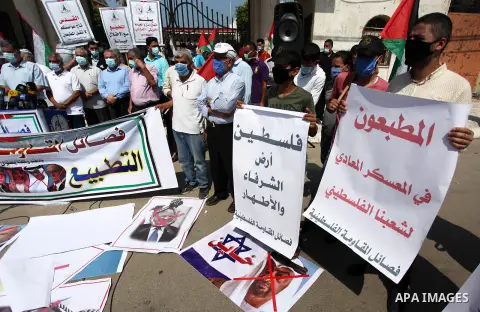 Palestinians hold banners during a protest to condemn the normalisation of ties between Israeli and Bahrain in Gaza city, on September 15, 2020. The Palestinian cause has long cemented ties between Middle East nations wi...