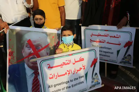 Palestinian protesters wearing protective masks, during a protest against the United Arab Emirates' and Bahrain's decisions to normalise relations with Israel, in Nuseirat in the central of Gaza Strip on September 15, 20...