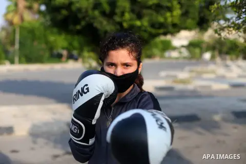 Palestinian girls train boxing in a public place, after the decision to close the gyms to avoid the spread of the Covid-19 coronavirus in Gaza city on Sept. 17, 2020. Photo by Mahmoud Ajjour