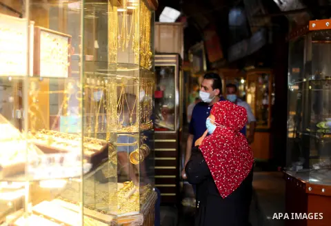 A Palestinian venedor wearing protective mask, displays jewellery at his jewellery store that reopened partially amid the coronavirus disease (COVID-19) crisis, in Gaza city, on September 20, 2020. Photo by Mahmoud Ajjou...