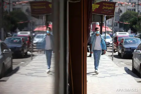Palestinian man wearing a face mask walks in the street after the easing of restrictions due to the COVID-19 pandemic in Gaza City on October 05, 2020. Photo by Mahmoud Ajjour