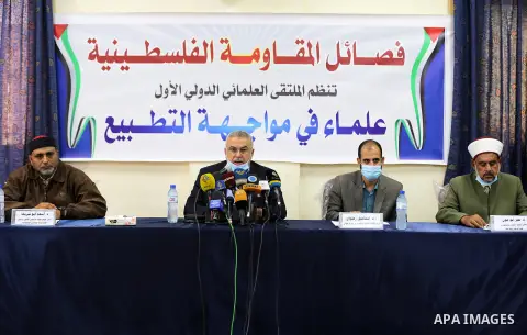 Members of the Palestinian factions and Scholars Association take part in the first international scientific conference entitled "Scholars Against Normalization", in Gaza city, on October 6, 2020. Photo by Mahmoud Nasser