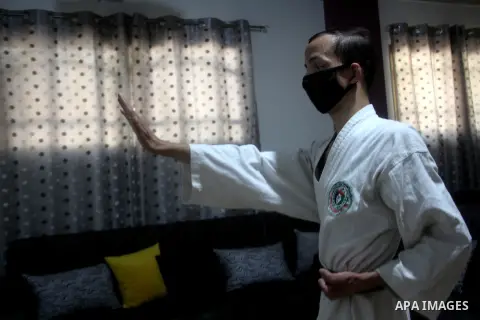 Blind Palestinian Moamen Al-Bitar, 20, trains karate at his home after the decision to close the gyms, amid the coronavirus disease (COVID-19) outbreak, in Gaza city on October 11, 2020. Photo by Mohammed Salem