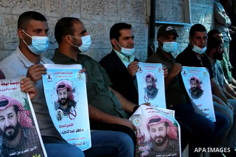 Palestinians take part in a protest to solidarity with prisoner Maher Al-Akhras on hunger strike helds in Israeli jails, in front of Red Cross office, in Gaza city on October 17, 2020. Photo by mohammed salem