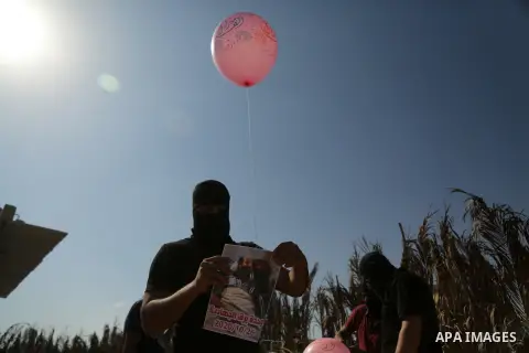 Palestinians prepare balloons attached with flammable materials to solidarity with prisoner Maher Al-Akhras on hunger strike helds in Israeli jails, at the Israel-Gaza border, in Gaza city on October 26, 2020. Photo by D...
