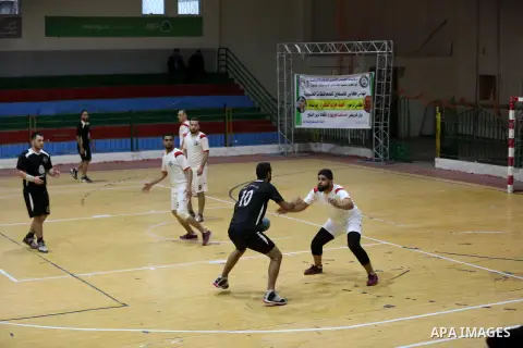 Palestinian handball players from the Etihad Deir Al-Balah (White) and khadamat Al-Bureij (Black) compete during the Cup Final in Saad Sayel gymnasium, in Gaza City on November 16, 2020. Photo by Ashraf Amra