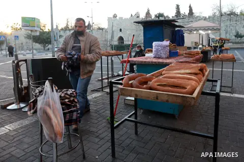 A Palestinian worker bakes Jerusalemite cakes in traditional bakery, in Jerusalem's Old City on November 30, 2020. Abu Sneina, a Palestinian who has been baking cakes for 90 years, Al-Maqdisi cakes is a civilization pass...