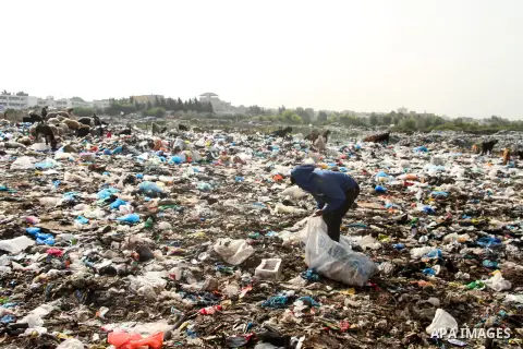 Palestinian children collect scrap from a garbage dump in the Bedouin village of "Umm Al-Nasr" in the northern Gaza Strip, on December 9, 2020. When the COVID-19 pandemic struck worldwide, humanitarian organizations in t...