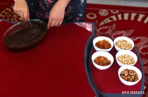 Palestinian girl, Hind Al-Mazyed, 22, makes a traditional food "Al-Mukhtoom", at her home in Deir al-Balah in the central Gaza Strip, on December 15, 2020. Al-Mazyed produces al-Mukhtoom to overcome harsh conditions and...