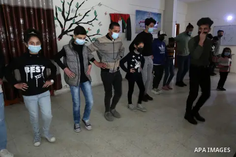 Palestinian youth perform a traditional dance "Dabke", during training in Gaza City, on January 21, 2021. Dabke is a traditional Bedouin dance and native Levantine folk dance. Dabke combines circle dance and line dancing...