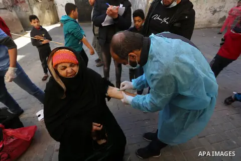 A Palestinian medical worker wearing protective gear, takes a random blood sample, in Deir al-Balah, central of Gaza Strip, on January 30, 2021. Safety and infection control teams at the Ministry of Health in the Gaza St...