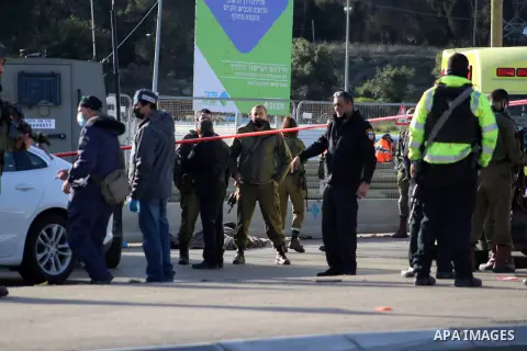 Members of Israeli security forces surround the body of a Palestinian man shot by Israeli security after reportedly attempting a knife attack, near the Israeli settlement of Gosh Etzion, north of Hebron city in the occup...