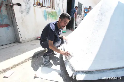 Palestinian maintain and repair the fishing boats using fiberglass material, at the Gaza seaport, on September 12, 2023. The boats began piling up in Gaza 15 years ago after Israel, imposed a land, air, and sea blockade...