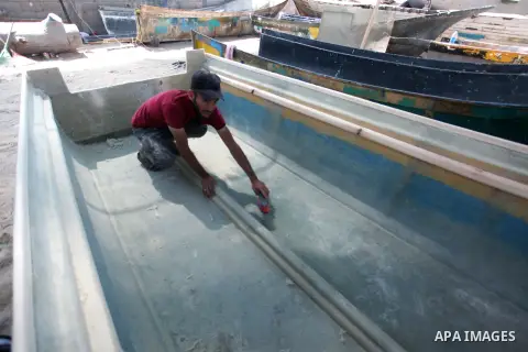 Palestinian maintain and repair the fishing boats using fiberglass material, at the Gaza seaport, on September 12, 2023. The boats began piling up in Gaza 15 years ago after Israel, imposed a land, air, and sea blockade...