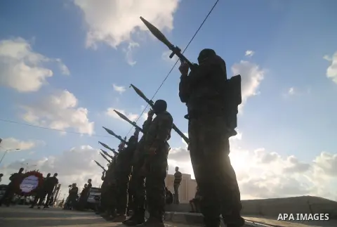 Palestinians and militants from the Palestinian factions participate in the opening of the memorial commemorating the 18th anniversary of the Israeli withdrawal from the Gaza Strip near the Rafah crossing, in the souther...