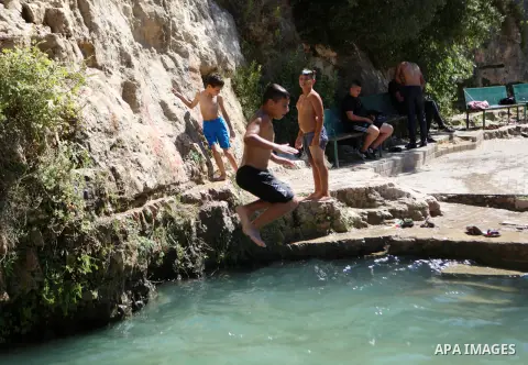Palestinians swim in the ancient spring in the West Bank village of Battir, located between Jerusalem and Bethlehem, on August 7, 2023, amid soaring temperatures. Photo by Mamoun Wazwaz