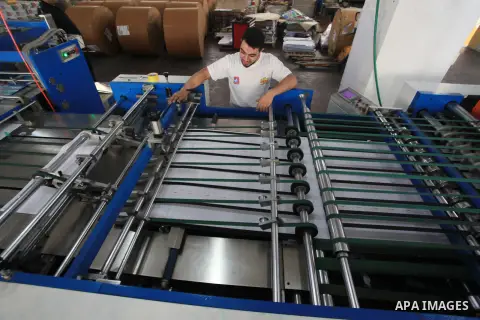 Palestinians work in a factory producing school notebooks before the start of the new school year, in Gaza city, on August 08, 2023. This is the first time that school notebooks are produced inside a factory in Gaza City...