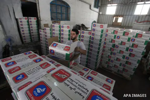 Palestinians work in a factory producing school notebooks before the start of the new school year, in Gaza city, on August 08, 2023. This is the first time that school notebooks are produced inside a factory in Gaza City...