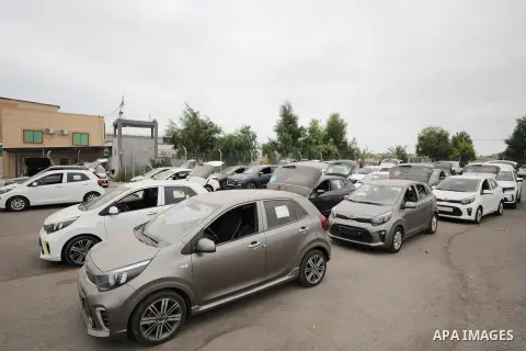 Palestinians check new vehicles entering through the Erez Crossing in Beit Hanoun in the northern Gaza Strip on August 14, 2023. Photo by Atia Darwish