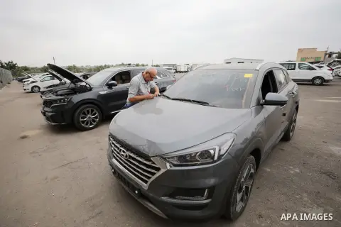 Palestinians check new vehicles entering through the Erez Crossing in Beit Hanoun in the northern Gaza Strip on August 14, 2023. Photo by Atia Darwish