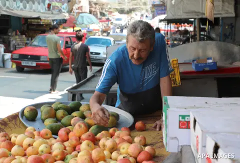 Palestinians buy vegetables and fruits, coinciding with the high prices, in the Al-Shati refugee camp market, west of Gaza City on August 29, 2023. Israeli authorities have escalated the policy of withholding the bodies...