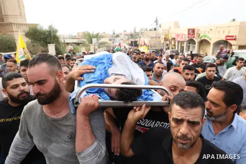 Mourners carry the body of Palestinian, Qusai al-Walaji, who was killed in an Israeli raid, during his funeral in the West Bank city of Jericho on August 15, 2023. Two Palestinians, including a minor, were early Tuesday...