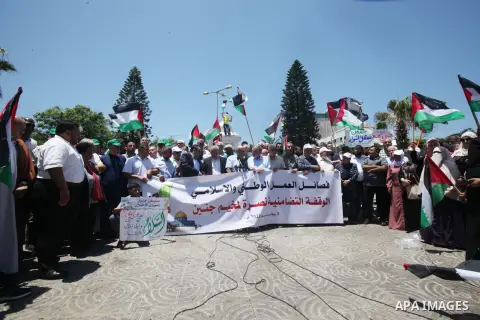 Palestinians lift national flags during a demonstration in Gaza City on July 3, 2023, protesting an Israeli military operation in the occupied West Bank. Israel has stepped up operations in the northern West Bank, home t...