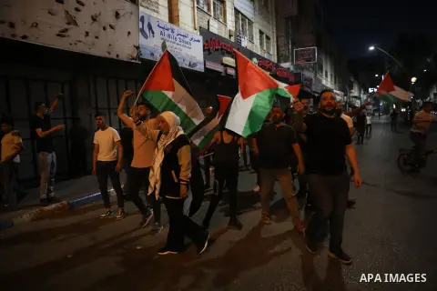 Palestinians shout slogans and hold placards during a demonstration in the West Bank city of Hebron protesting an Israeli military operation in Jenin for the second day, on July 4, 2023. Eight Palestinians were shot and...