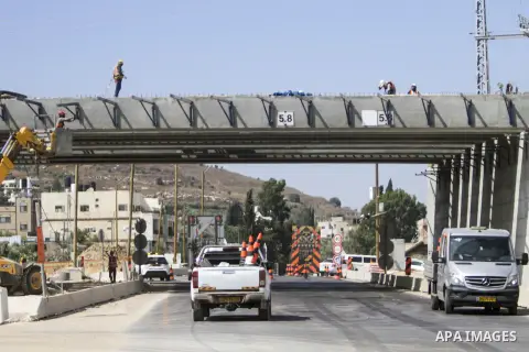Israeli workers build a bridge on a public road for settlers in the town of Hawara, south of Nablus, in the West Bank on July 10, 2023. In recent months, violence broke out between Palestinians and Israelis in the town o...