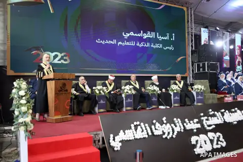 Palestinian students take part in their graduation ceremony in the West Bank city of Hebron on July 15, 2023. Photo by Mamoun Wazwaz\ apaimages