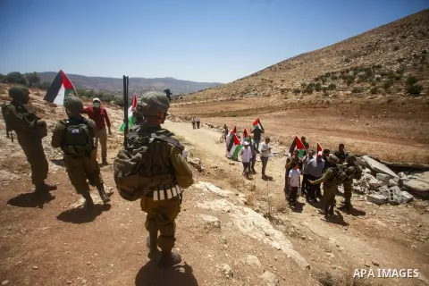 Palestinians argue with Israeli forces during a protest against the establishment of Israeli outposts, in Beit Dajan, east of the West Bank city of Nablus, on July 21, 2023. Photo by Mohammed Nasser\ apaimages
