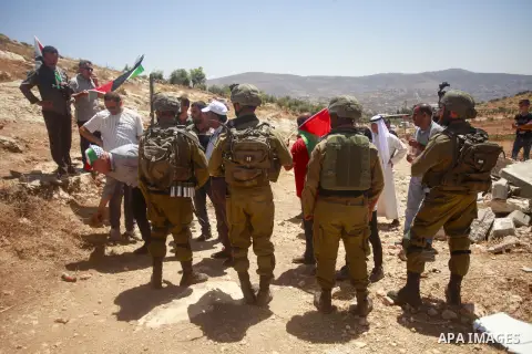 Palestinians argue with Israeli forces during a protest against the establishment of Israeli outposts, in Beit Dajan, east of the West Bank city of Nablus, on July 21, 2023. Photo by Mohammed Nasser\ apaimages