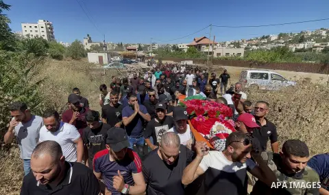 Mourners carry the body of Palestinian Mohammed al-Bayyed who was killed during clashes with Israeli forces while a protest against Israeli settlements during his funeral at Jalazoun refugee camp in the West Bank city of...